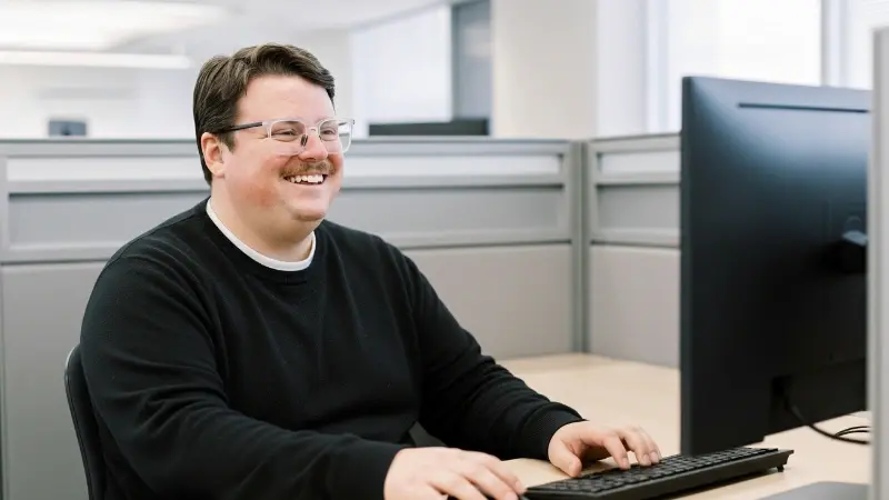 Corey sitting at a desk working on a computer